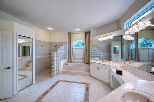 bathroom featuring vanity, tile patterned floors, and plus walk in shower