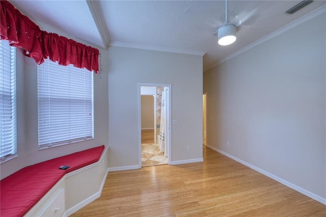 interior space featuring crown molding and light hardwood / wood-style flooring