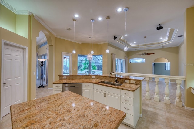 kitchen featuring sink, dishwasher, white cabinets, and a spacious island