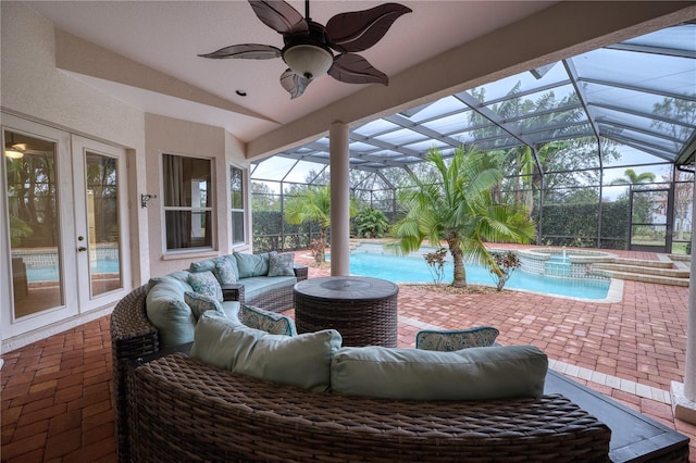 view of patio / terrace with ceiling fan, glass enclosure, an outdoor living space, french doors, and an in ground hot tub