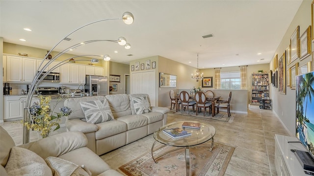 living room featuring a notable chandelier