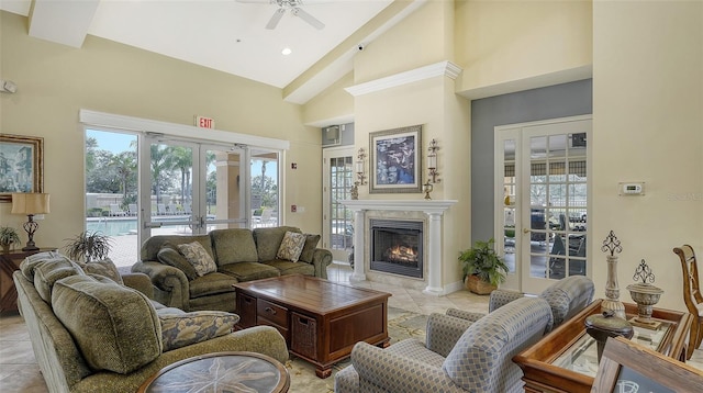 tiled living room with french doors, ceiling fan, and vaulted ceiling