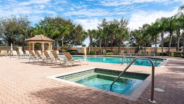 view of swimming pool with a community hot tub and a gazebo