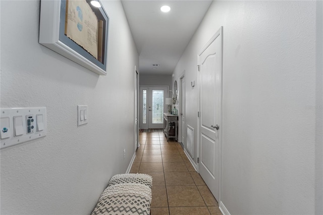 hallway with dark tile patterned flooring