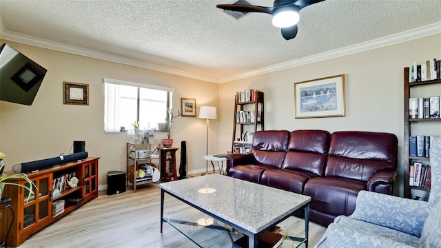 living room with crown molding, ceiling fan, a textured ceiling, and light hardwood / wood-style floors