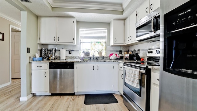 kitchen featuring white cabinetry, sink, crown molding, and stainless steel appliances