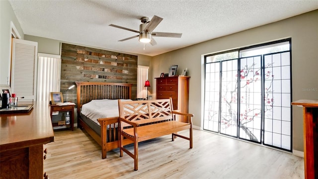 bedroom with light hardwood / wood-style floors and a textured ceiling