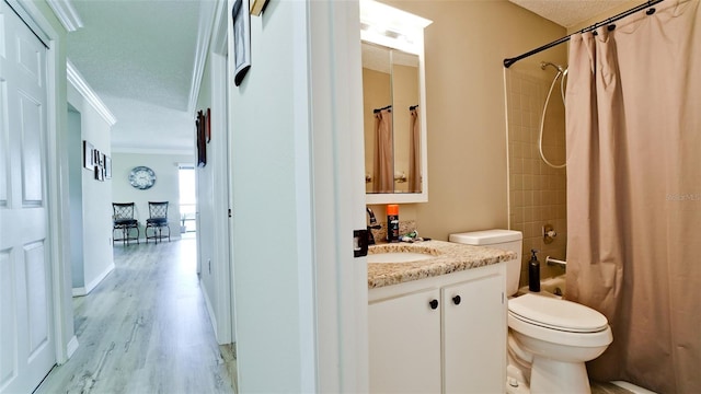 full bathroom featuring toilet, crown molding, vanity, shower / bath combo, and hardwood / wood-style floors