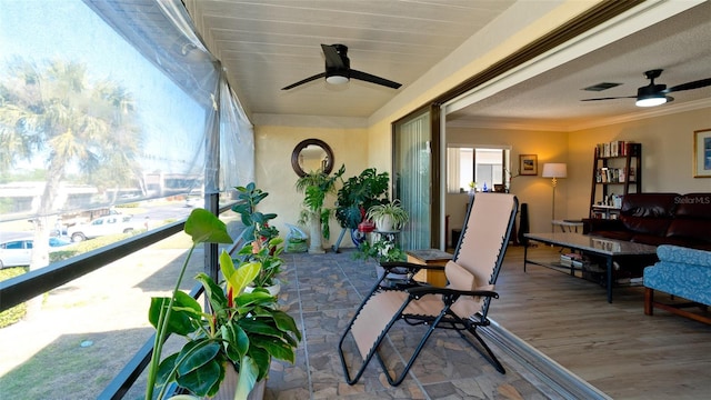 sunroom / solarium with ceiling fan