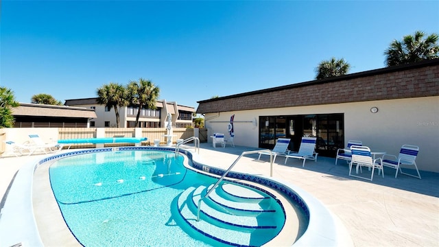 view of swimming pool featuring a patio area