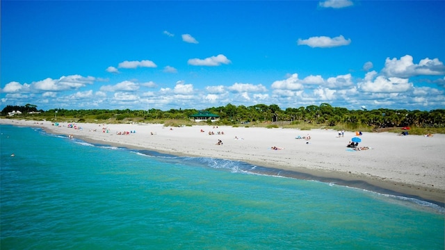 birds eye view of property with a water view and a view of the beach