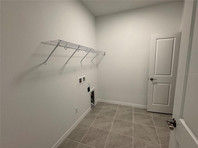 washroom featuring light tile patterned flooring and hookup for a washing machine