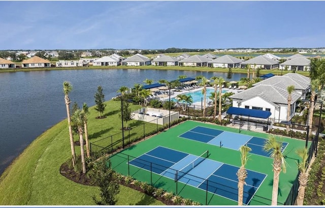 drone / aerial view featuring a residential view and a water view