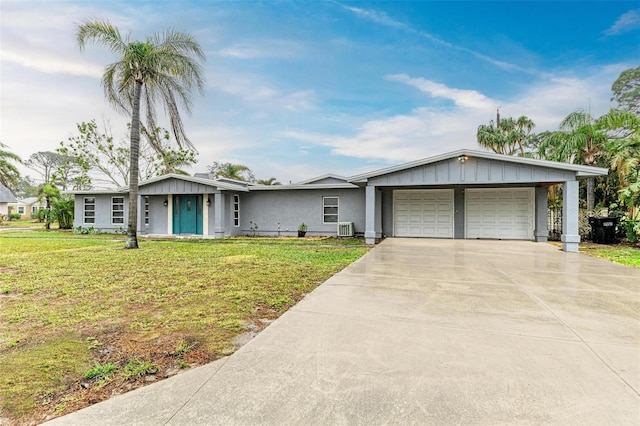 ranch-style house featuring a garage and a front lawn