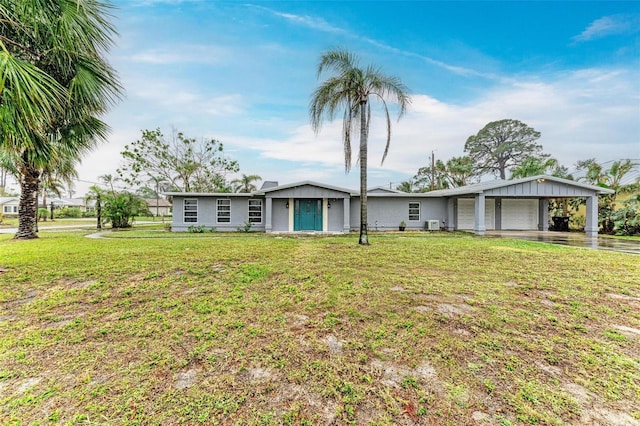 ranch-style home featuring a garage, driveway, and a front lawn