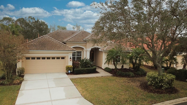 mediterranean / spanish-style home with a garage and a front yard