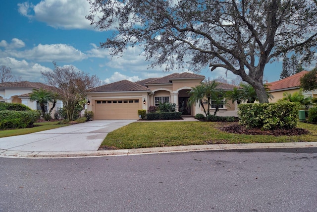 mediterranean / spanish home featuring a garage and a front lawn