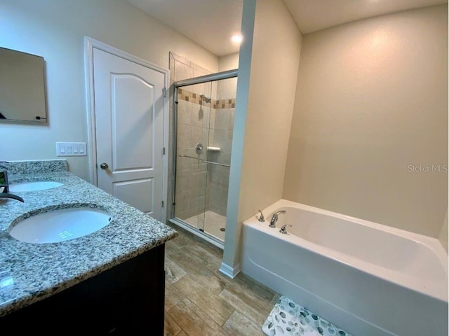 bathroom with independent shower and bath and vanity