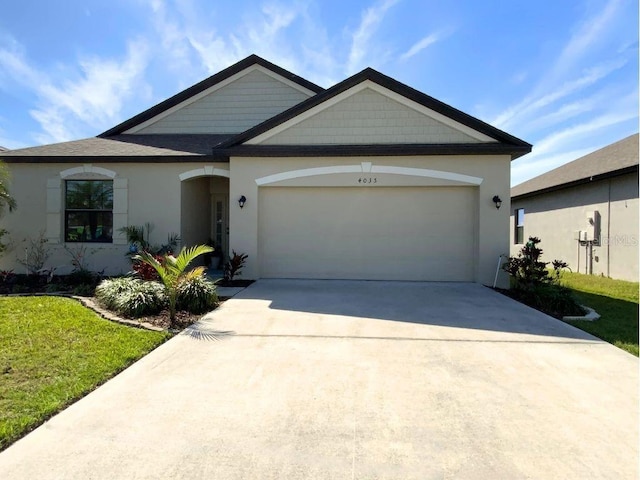 view of front of house featuring a garage, driveway, and stucco siding