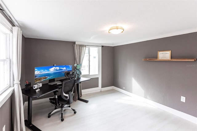 home office featuring wood-type flooring, ornamental molding, and a textured ceiling