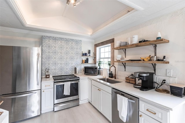 kitchen featuring backsplash, stainless steel appliances, sink, and white cabinets