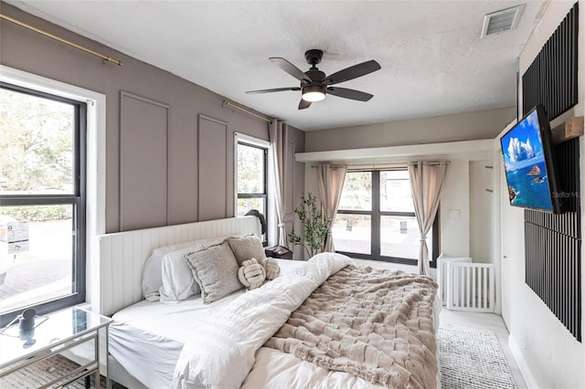 bedroom with a textured ceiling and ceiling fan