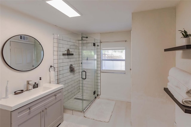 bathroom with vanity and a shower with shower door