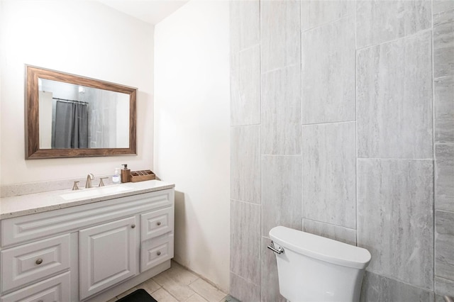 bathroom with vanity, tile patterned flooring, and toilet