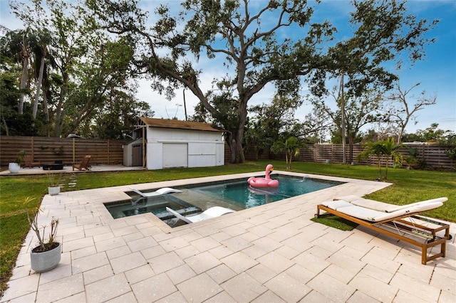 view of swimming pool featuring a patio area, a shed, and a lawn