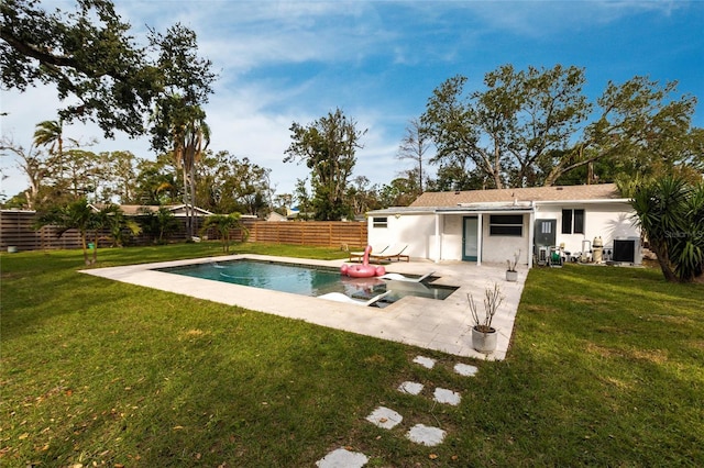 view of swimming pool featuring a lawn, central air condition unit, and a patio area