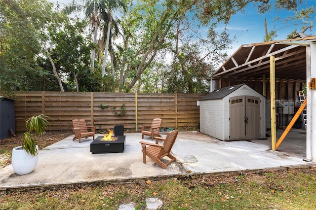 view of patio / terrace with a storage shed and an outdoor fire pit