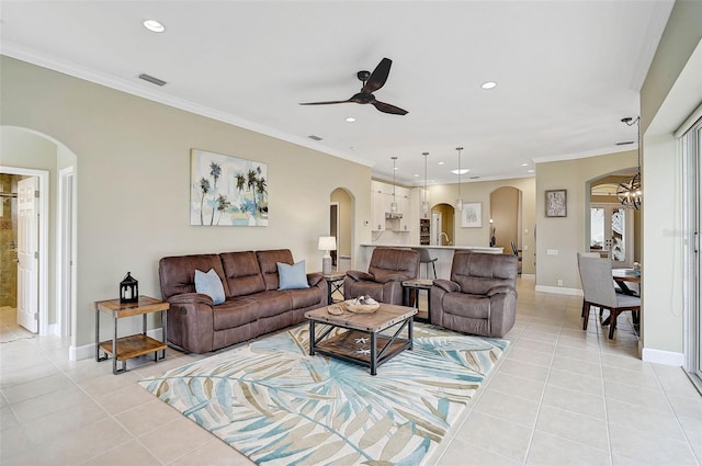 living room with light tile patterned floors, ornamental molding, and ceiling fan