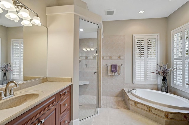 bathroom featuring tile patterned flooring, vanity, a notable chandelier, and shower with separate bathtub