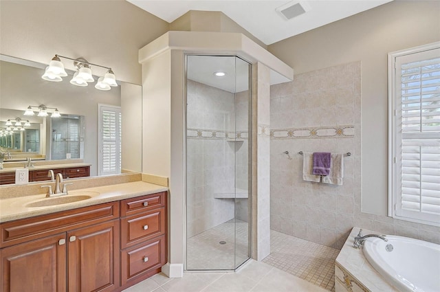 bathroom featuring vanity, plenty of natural light, tile patterned floors, and separate shower and tub