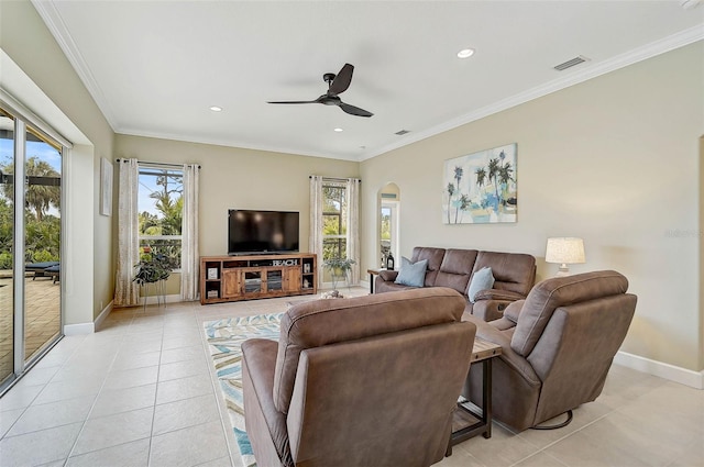 tiled living room with ornamental molding and ceiling fan