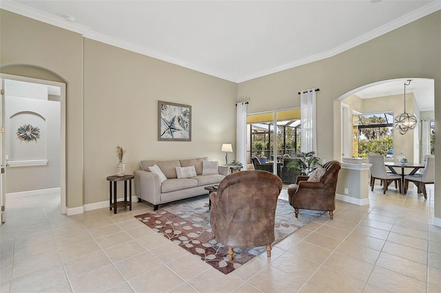 tiled living room featuring crown molding and a notable chandelier