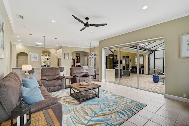 living room featuring crown molding, ceiling fan with notable chandelier, and light tile patterned floors