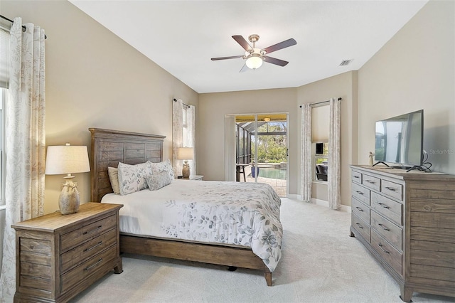 carpeted bedroom with ceiling fan and access to exterior