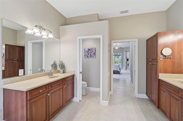 bathroom featuring vanity, toilet, and tile patterned flooring