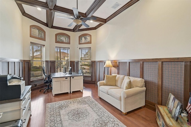 office space with hardwood / wood-style flooring, crown molding, coffered ceiling, and beam ceiling