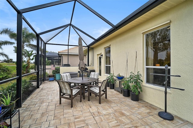 view of patio featuring glass enclosure