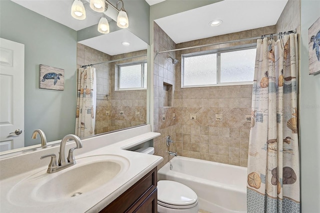 full bathroom with shower / bath combination with curtain, vanity, and toilet