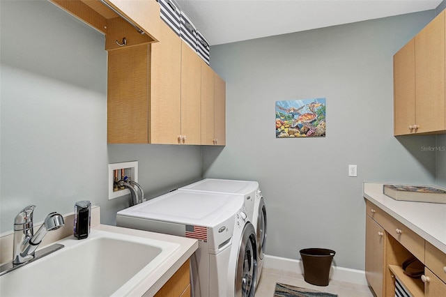 laundry area featuring sink, cabinets, washing machine and clothes dryer, and light tile patterned flooring