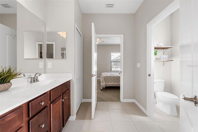 bathroom with vanity, toilet, and tile patterned flooring