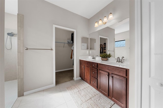 bathroom featuring vanity, a shower, and tile patterned flooring