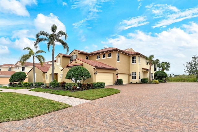 mediterranean / spanish-style house with a garage and a front yard