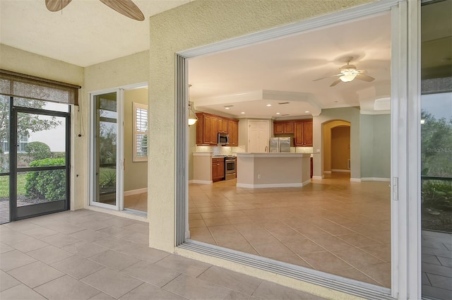 interior space with ceiling fan and light tile patterned floors