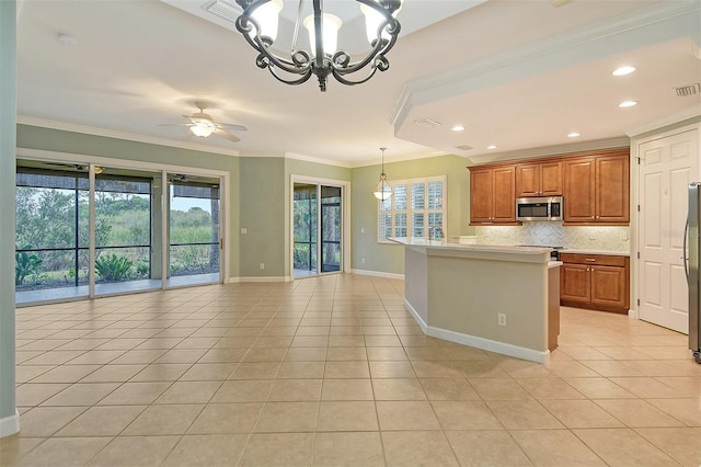 kitchen featuring light tile patterned flooring, appliances with stainless steel finishes, decorative backsplash, hanging light fixtures, and ornamental molding