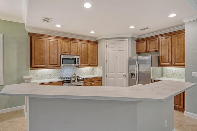 kitchen featuring stainless steel appliances, ornamental molding, light tile patterned floors, and a kitchen bar