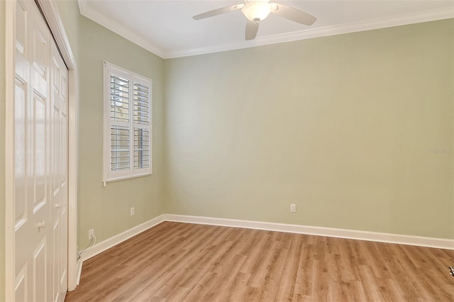 empty room with crown molding, ceiling fan, and light hardwood / wood-style floors